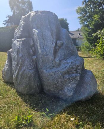 An artificial rock standing on grass