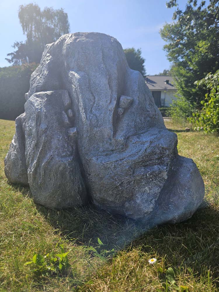 An artificial rock standing on grass