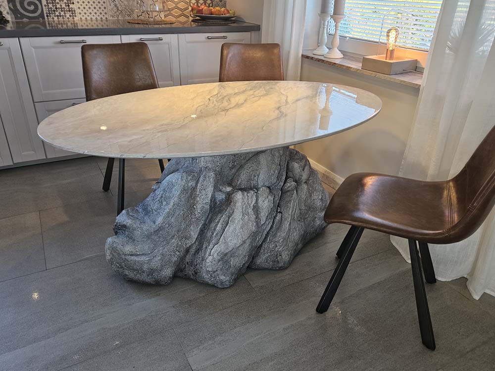 A kitchen table with hand made top and rock table leg